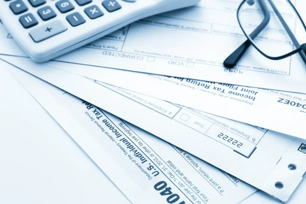 Calculator and medical forms showing the financial impact of ineffective personal injury billing services