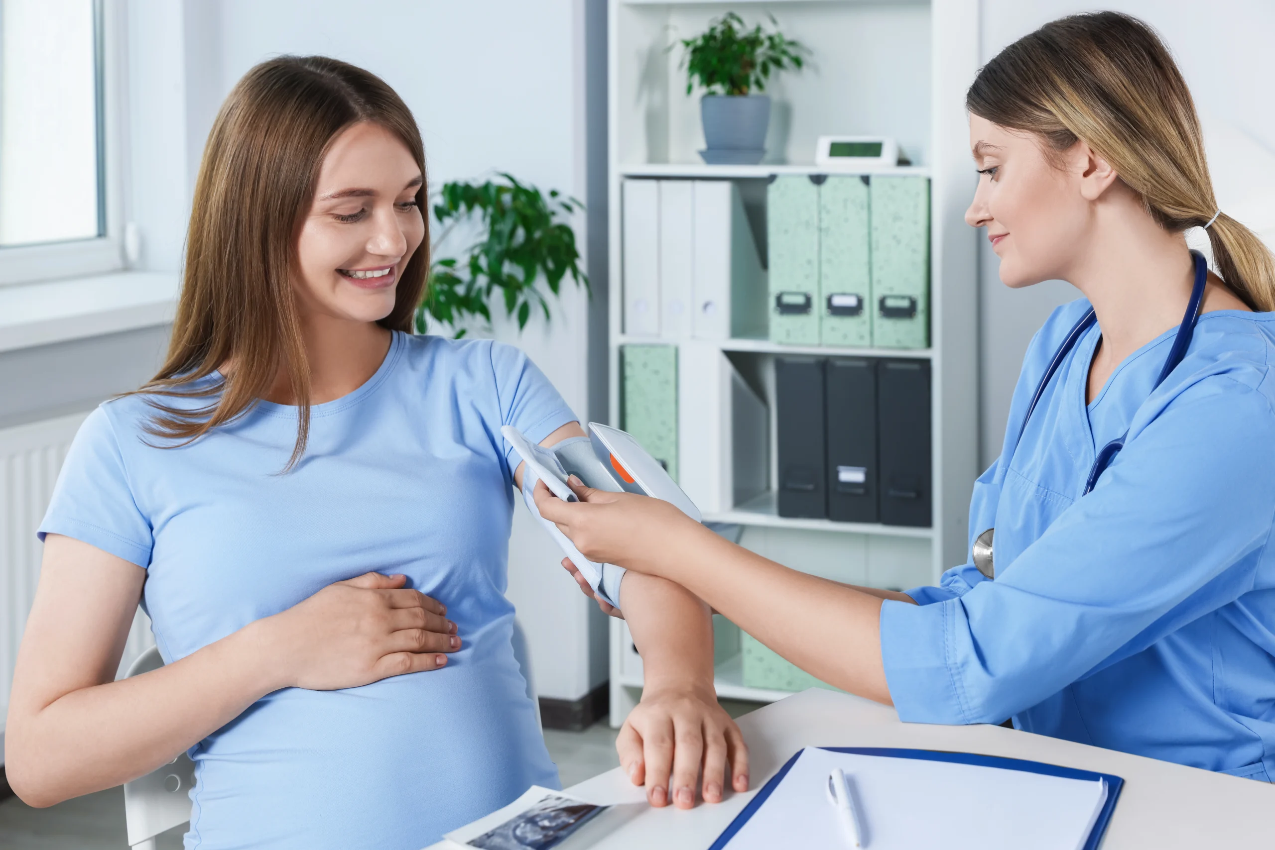 Physician measuring a pregnant patient's blood pressure during antepartum care billed with CPT 59400 before the 2027 transition