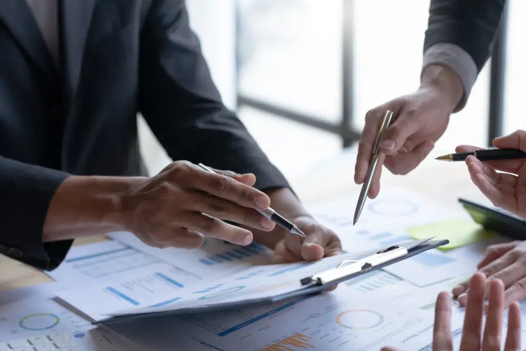 Healthcare team reviewing claims data to evaluate outsourcing claims processing options