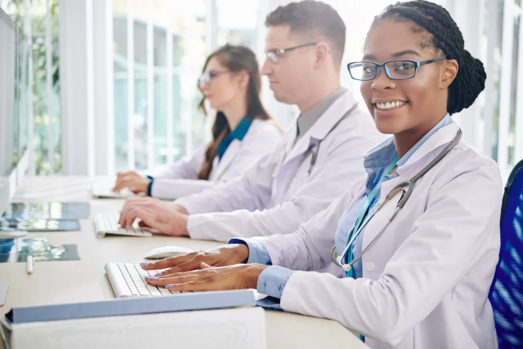  Medical professionals working in a bright office, representing the provider credentialing and payer enrollment steps handled by medical credentialing services